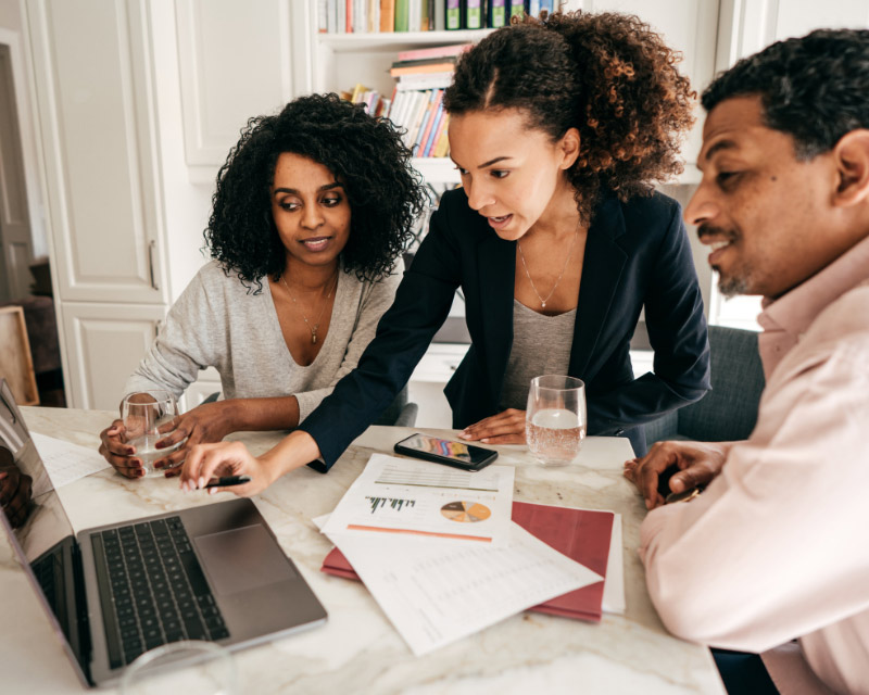 Leaders look at laptop together.