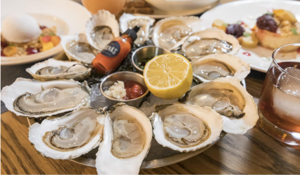 Plate full of half-shell oysters.